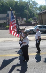 The VFW carrying the flag.  Everyone stands up.