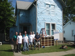 The house cleared of the old siding and with the vinyl started.  Our crew in front