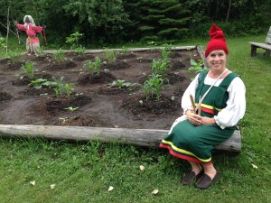 A garden gnome? No - Val in historic dress with a voyageur cap